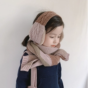 Detail shot of a knitted candy-colored earmuff and scarf set on a child model