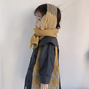 Detail of kids knit scarf, ear warmers and diamond pattern shoulder bag in yellow