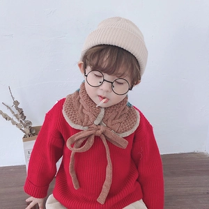 Close-up of brown knit neck warmer with cable pattern and plush lining on a child model