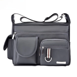 Detail of waterproof dark grey messenger bag showing multi-pocket design and metal zippers