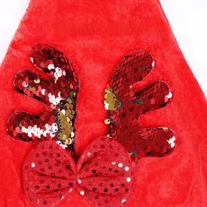 Detail of red Christmas hat with reversible red and gold sequins on plush reindeer antlers