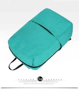 Detailed close-up of woven turquoise polyester fabric on casual travel backpack with black strap