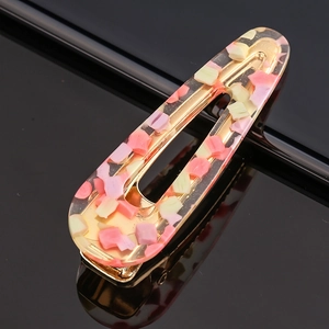 Detail of floral acetate hair clip with gold alloy base and pink mosaic resin finish