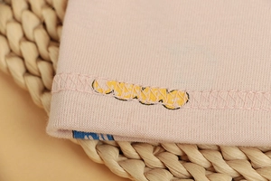 Detail of baby cotton beanie featuring reinforced flat double stitching and soft knit texture