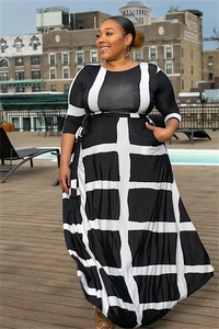 Close-up of a plus size maxi dress featuring black and white geometric stripe patterns