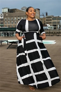 Detail of plus size maxi dress featuring black and white geometric prints and waist tie