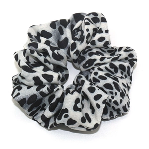 Elastic scrunchie hair tie with classic black and white leopard print pattern