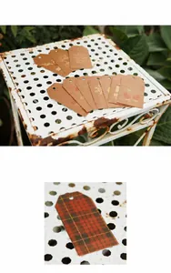 Close-up of vintage kraft paper and red plaid Christmas gift tags with reindeer patterns