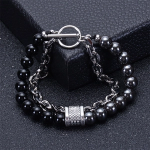 Macro shot of double-layer men's bracelet with black onyx beads and silver chain link