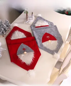 Detail view of red and grey Christmas gnome chair covers with plush beards and felt caps