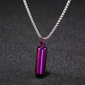 Close-up of a purple cylinder capsule pendant with a silver stainless steel chain necklace