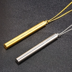 Hip hop style titanium steel cylinder necklaces in gold and silver on a black surface