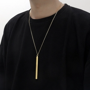 Hip hop style gold cylindrical pendant necklace for men and women on a black t-shirt