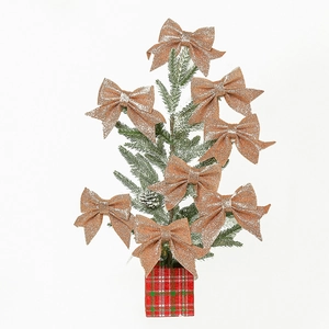 Champagne gold glitter bows on a small Christmas tree with red and green plaid base
