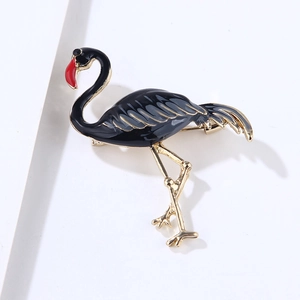 Detail of flamingo brooch with black enamel, red beak and gold metallic pin back