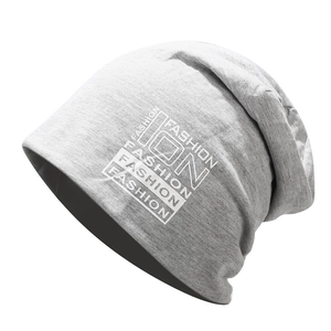 Detail of light gray slouchy beanie with white FASHION ON print and soft knit texture
