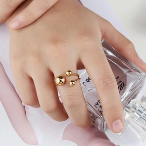 Minimalist gold double-line stainless steel ring with three spherical beads on hand