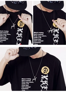 Three-way close-up views of a silver poodle dog pendant necklace worn by a male model