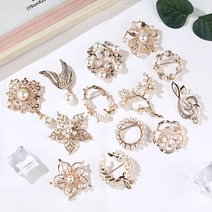 Set of 12 elegant gold-plated flower and swan brooches with pearls and rhinestones