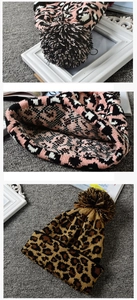 Detail of leopard print knitted beanies with soft pom-poms and warm thick fabric textures