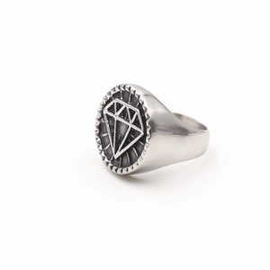 Detailed side view of a silver punk ring featuring a diamond geometric logo on a seal face
