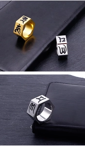 Close-up of hexagonal stainless steel rings with Sanskrit mantras in gold and silver finish