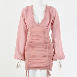 Detail of pink long sleeve dress with ruffled deep V-neckline and ruched body design