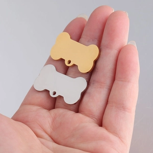 Polished stainless steel bone-shaped dog tags in gold and silver finish, 16x31mm size