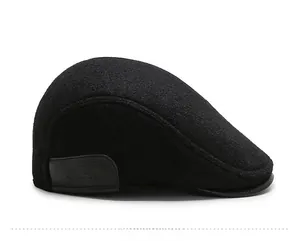 Detail view of the black wool beret side with Glacier embossed leather patch