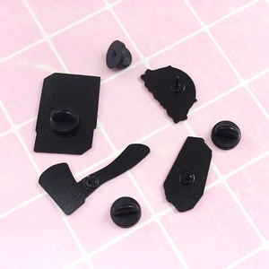 Detail view of black enamel pins backings with durable rubber clutch butterfly clasps