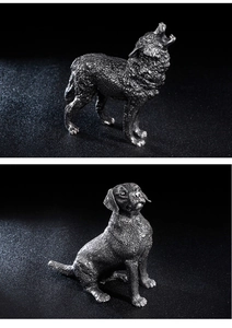 Detail of vintage stainless steel dog sculptures with fine fur texture and metal finish
