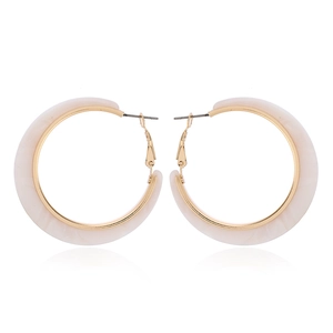 Close-up of cream acetate C-shaped hoop earrings with gold-tone metal hardware details