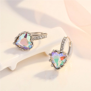 Macro shot of silver heart earrings with iridescent stones and clear zirconia accents