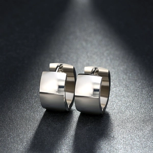 Macro shot of silver wide-band stainless steel hoop earrings with high-polished mirror finish