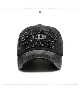 Detail of vintage washed black cotton baseball cap with embroidered ORIGINAL THE BLACK text