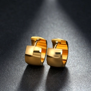 Detailed close-up of chunky gold-plated stainless steel hoop earrings with polished finish