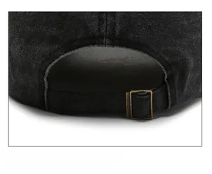 Macro detail of washed denim baseball cap featuring adjustable antique brass metal buckle