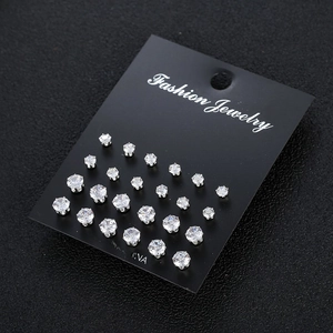 Detail view of 12 pairs of sparkling cubic zirconia stud earrings on black card