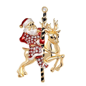 Festive Santa Claus riding a reindeer carousel brooch with gold plating and crystals
