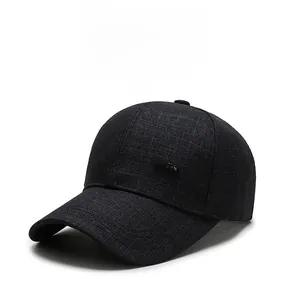 Detail of gray plaid fabric texture and side metal emblem on the men's baseball cap