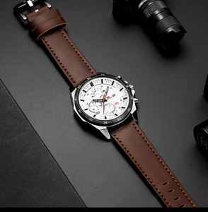 Close-up of men's chronograph watch with silver case, white dial and brown leather strap