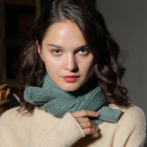 Knitted green winter scarf for women and children made of soft ribbed thermal wool