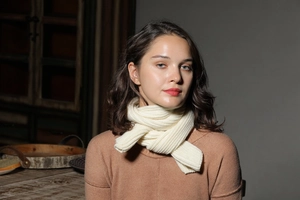 Detail of white rib-knit scarf showing soft texture and cozy winter styling on model