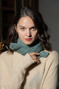 Close-up of the ribbed knit texture on this warm dark green winter scarf for women