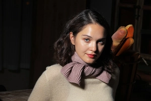 Close-up of mauve ribbed knit scarf texture paired with a beige cashmere sweater
