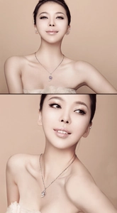 Close-up of elegant silver necklace with streamline gemstone pendant on model