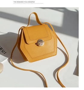 Detail of ginger leather bag featuring hexagon structure and gold twist lock closure