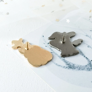 Back view of metal cat and pumpkin brooches with secure butterfly pin clasps