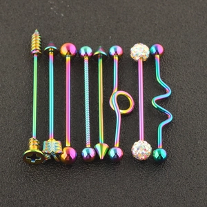 Close-up of rainbow plated industrial barbells set in surgical steel with assorted ends