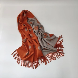 Close-up of double-sided camellia pattern jacquard scarf with soft tassel details